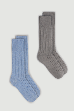 Two pairs of merino ribbed bed socks, one blue and one gray, on a white background.