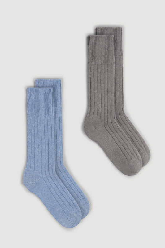 Two pairs of merino ribbed bed socks, one blue and one gray, on a white background.
