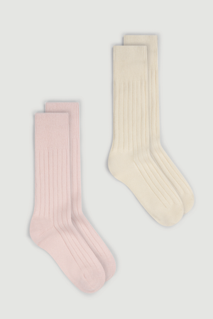 Two pairs of merino ribbed bed socks, one pink and one cream, on a white background.