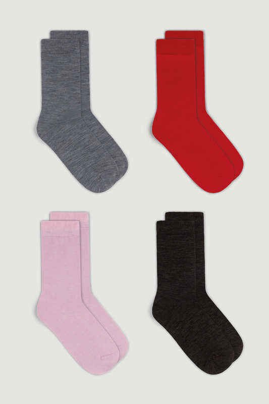 Four pairs of merino calf length socks in grey, red, pink, and dark brown on a white background