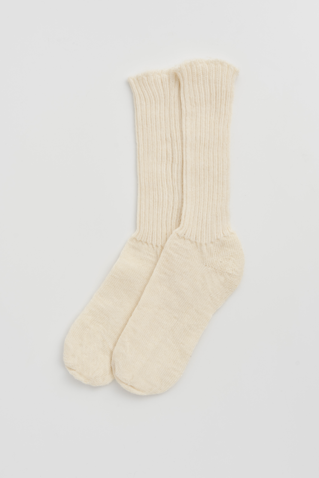 Pair of cream ribbed mohair socks on a light grey background