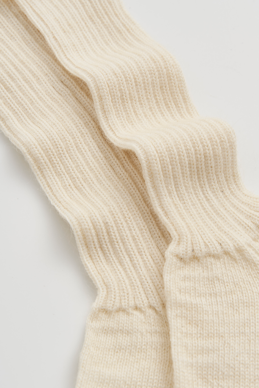 Close-up of cream ribbed mohair socks on a light background