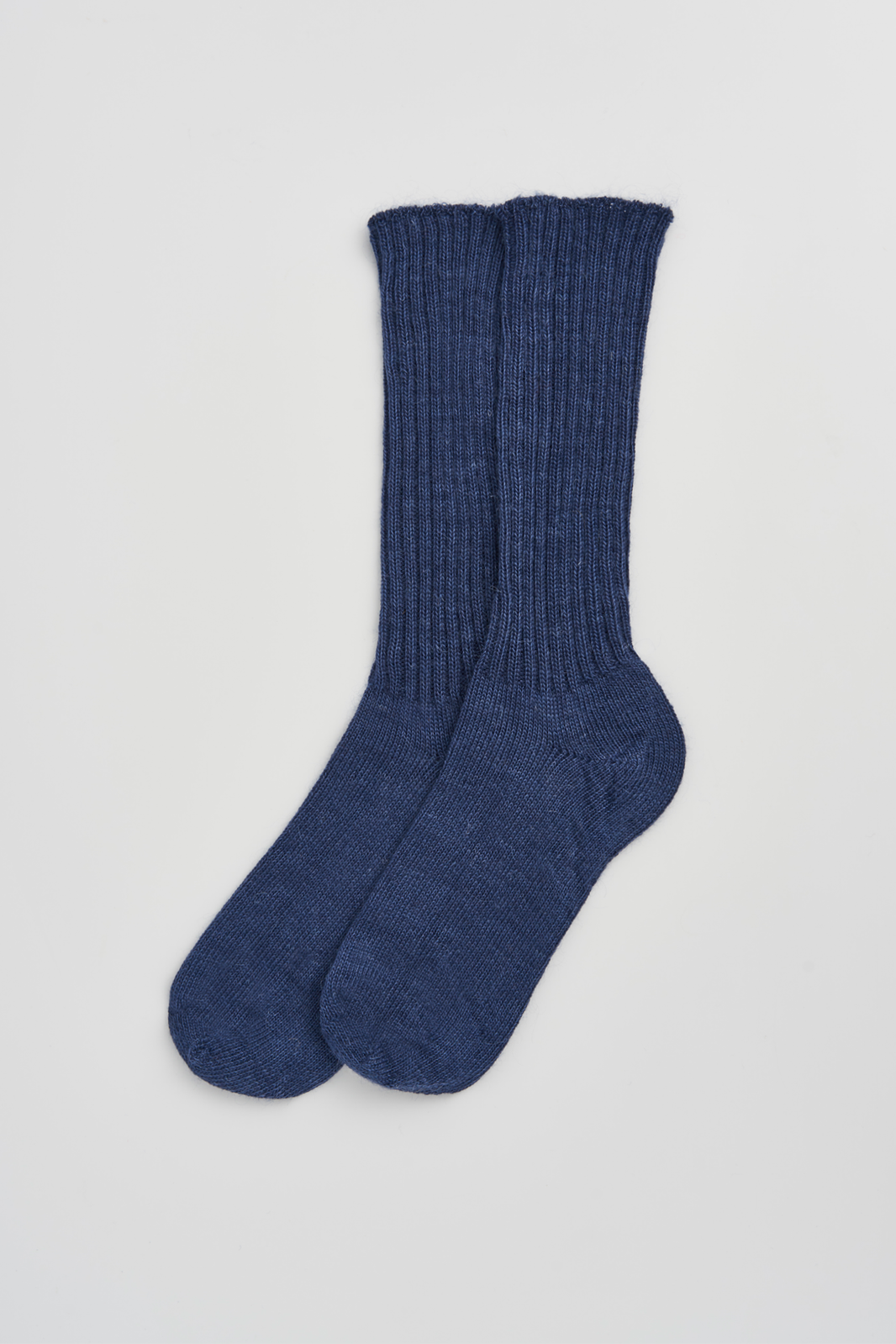 Pair of blue ribbed mohair socks on a light grey background