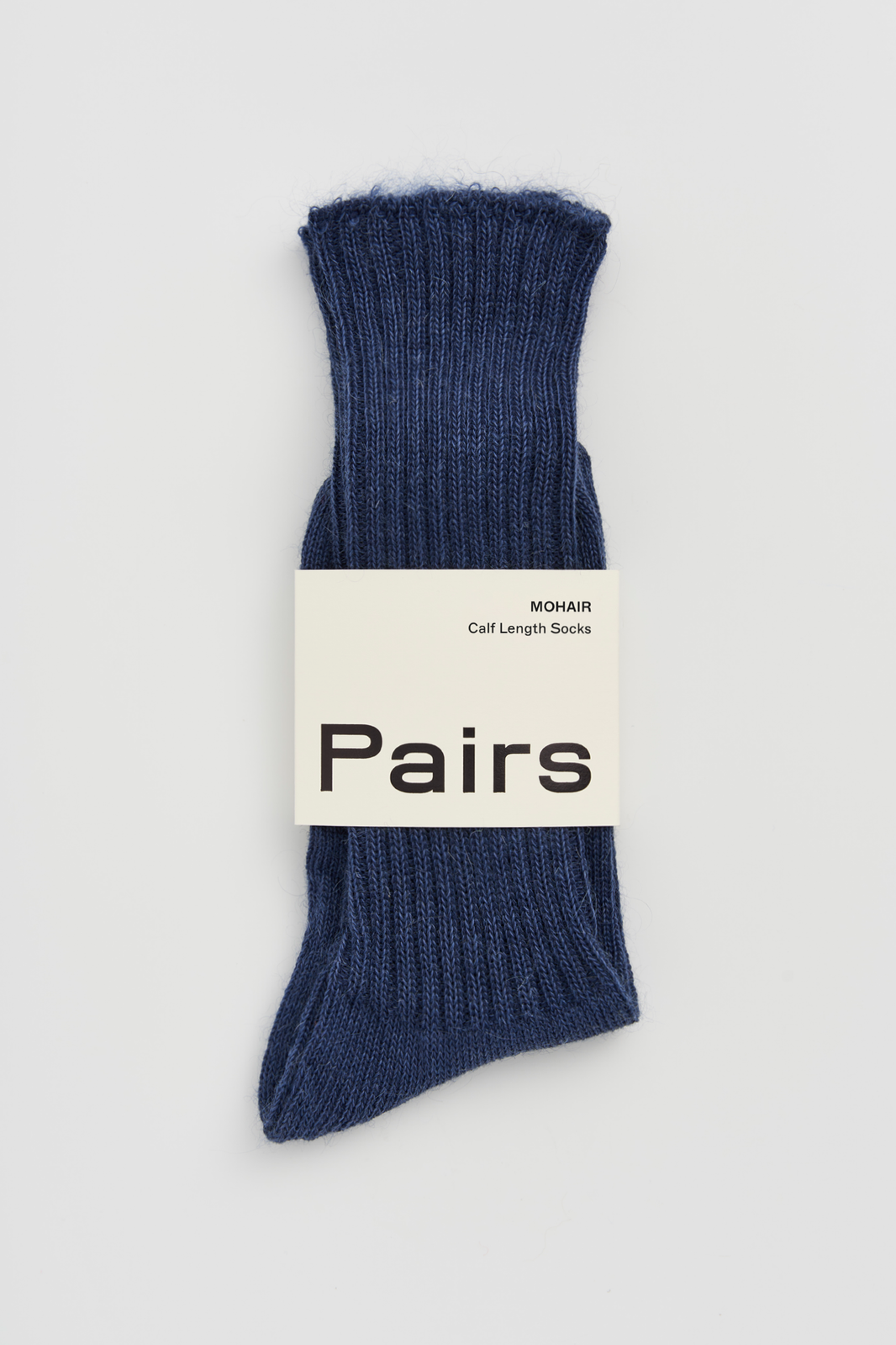 Pair of blue ribbed mohair socks with a 'Pairs' packaging band on a light grey background