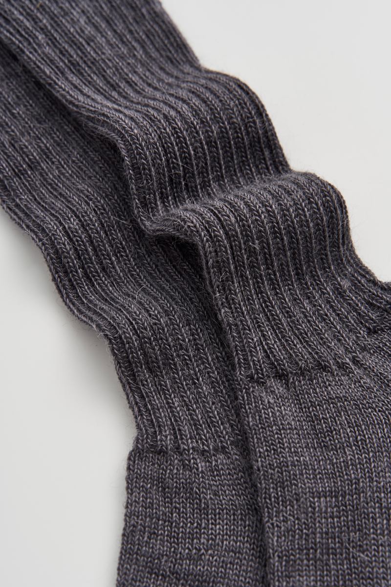 Close-up of grey ribbed mohair socks on a light grey background