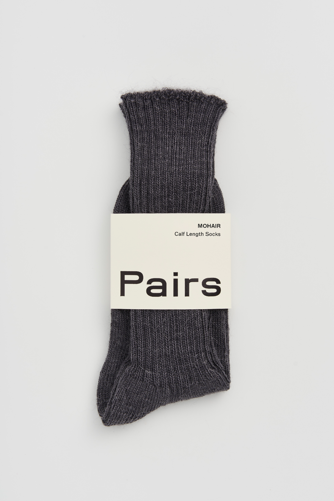 Grey ribbed mohair socks with a 'Pairs' packaging band on a light grey background