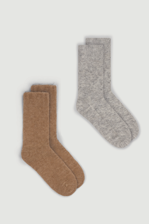 Two pairs of ultra soft plain alpaca bed socks, one light brown and one light grey, on a white background.