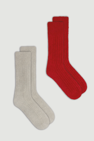 Two pairs of ultra soft ribbed alpaca bed socks, one red and one light grey, on a white background.