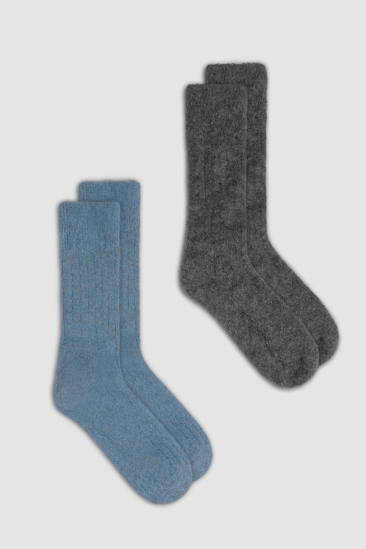 Two pairs of ultra soft ribbed alpaca bed socks , one blue and one dark grey, on a white background.