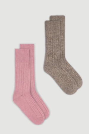 Pair of pink and light brown ultra soft ribbed alpaca bed socks on a white background