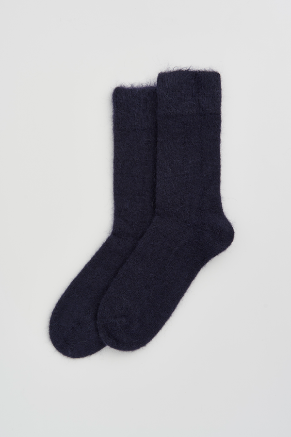 Pair of navy ultra soft alpaca socks on a light grey background