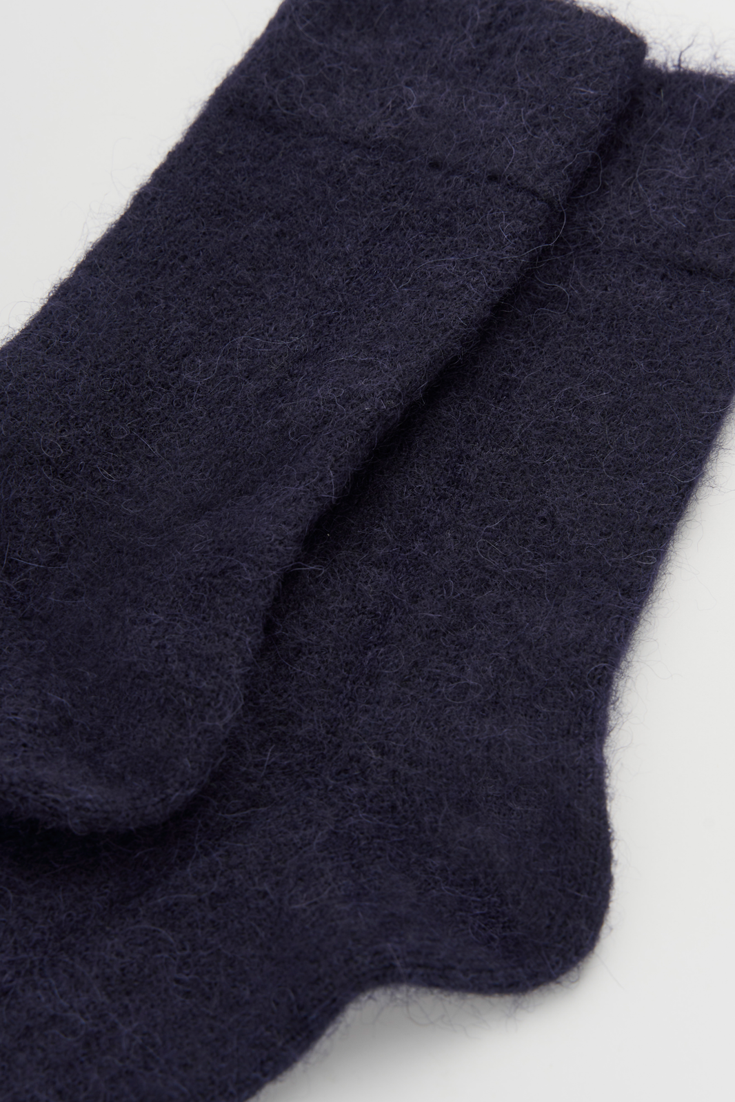 Navy ultra soft alpaca socks on a light grey background