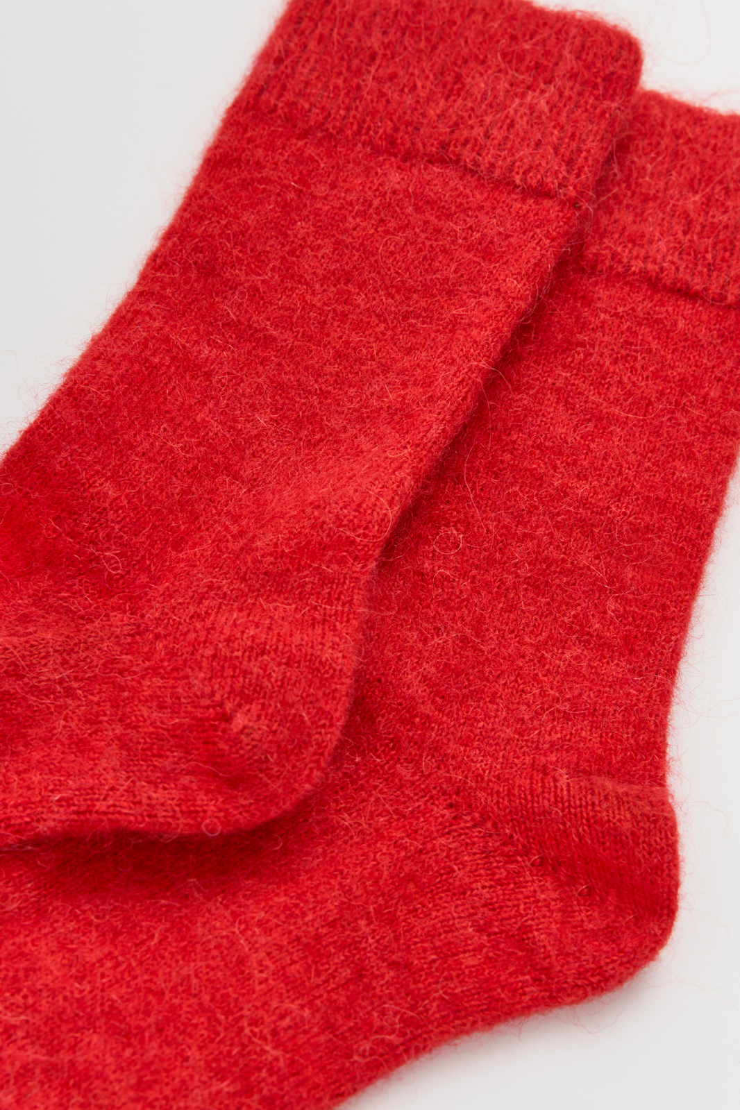 Red ultra soft alpaca socks on a light grey background