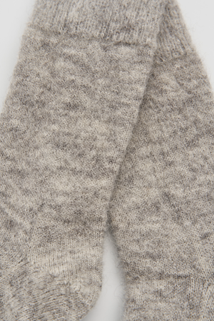 Close-up of a pair of grey ultra soft alpaca bed socks on a white background