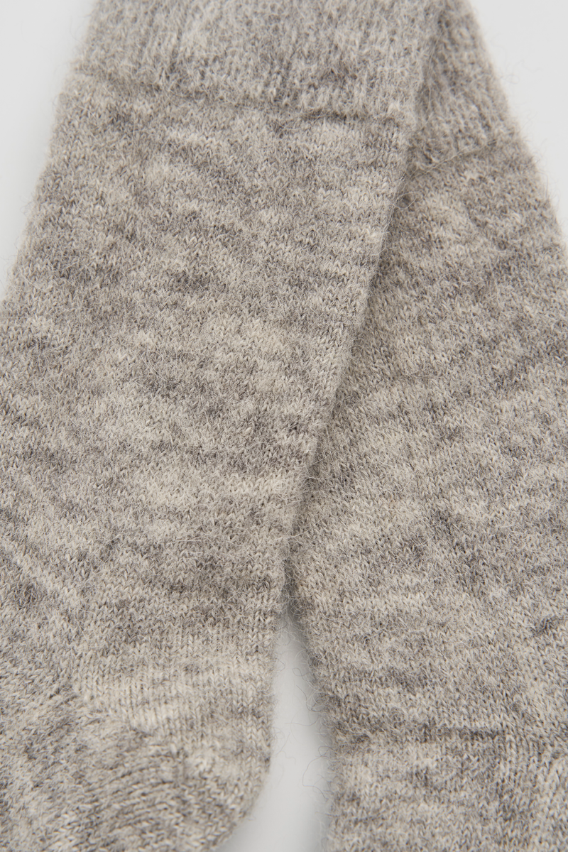 Close-up of a pair of grey ultra soft alpaca bed socks on a white background