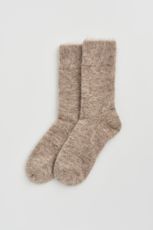 Pair of oatmeal ultra soft alpaca bed socks on a light grey background