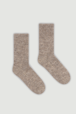 Pair of oatmeal plain alpaca bed socks on a white background