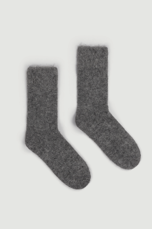 Pair of dark grey ultra soft plain bed socks on a light grey background