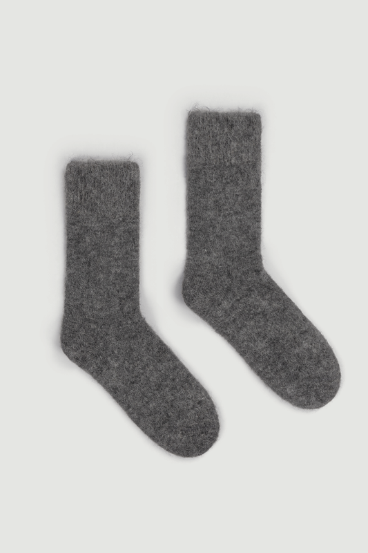 Pair of grey ultra soft plain alpaca bed socks on a white background