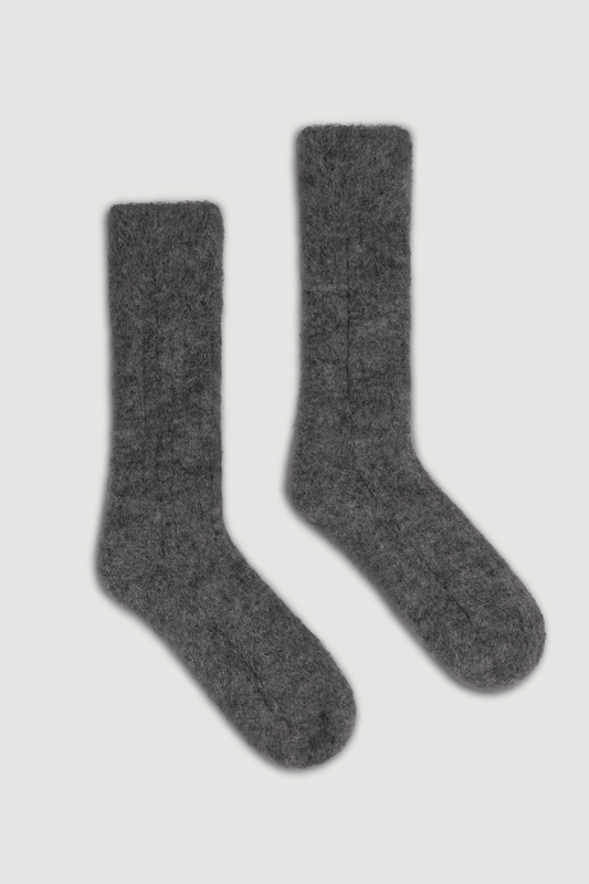 Pair of dark grey ultra soft ribbed alpaca bed socks on a white background