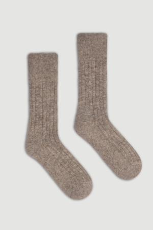 Pair of oatmeal ultra soft alpaca ribbed bed socks on a light grey background
