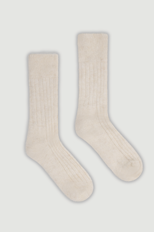 Pair of cream ultra soft ribbed alpaca bed socks on a white background