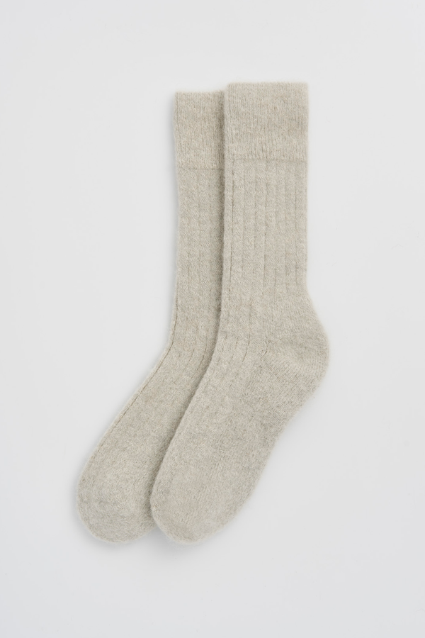 Pair of light grey ribbed ultra soft alpaca bed socks on a white background