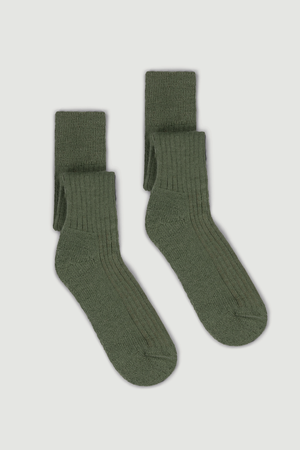 Pair of green wool knee high socks on a white background