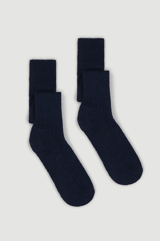 Pair of navy wool knee high socks on a white background