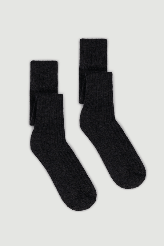 Pair of dark grey wool knee high socks on a white background