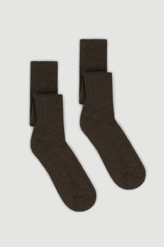 Pair of brown wool knee high socks on a white background