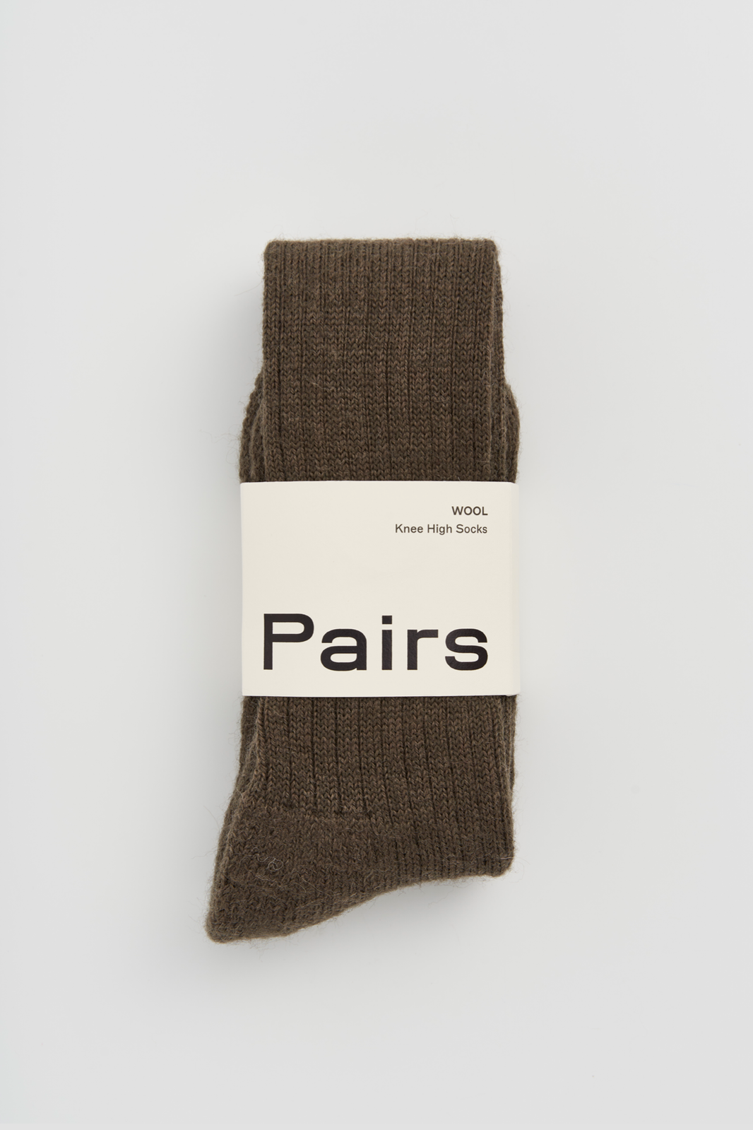 Muddy green wool knee high sock with a 'Pairs' packaging band on a light grey background