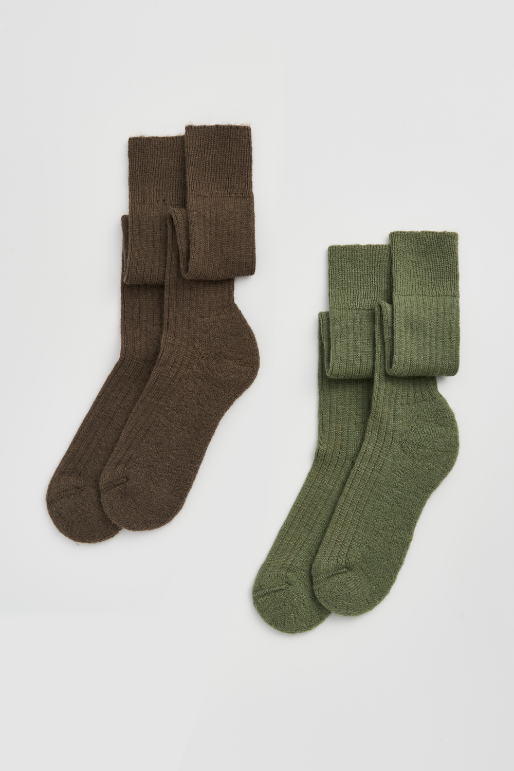 Two pairs of wool knee high socks, one brown and one green, on a light grey background.