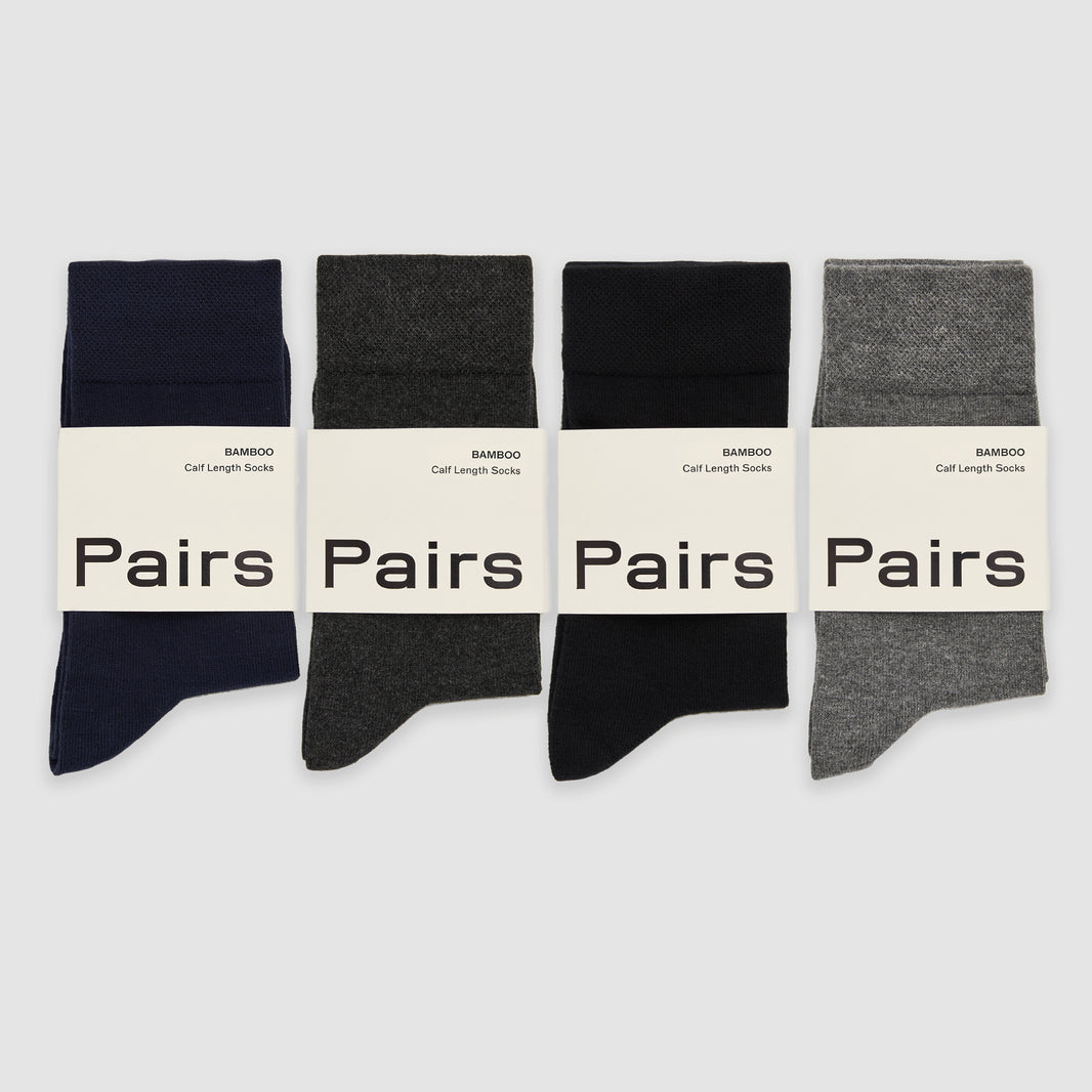 Four pairs of bamboo socks in black, gray, and navy on a white background with 'Pairs' branding.