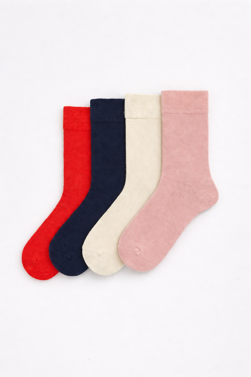 Set of four bamboo socks making up the Pale and Bright collection, featuring red, blue, cream and pink.